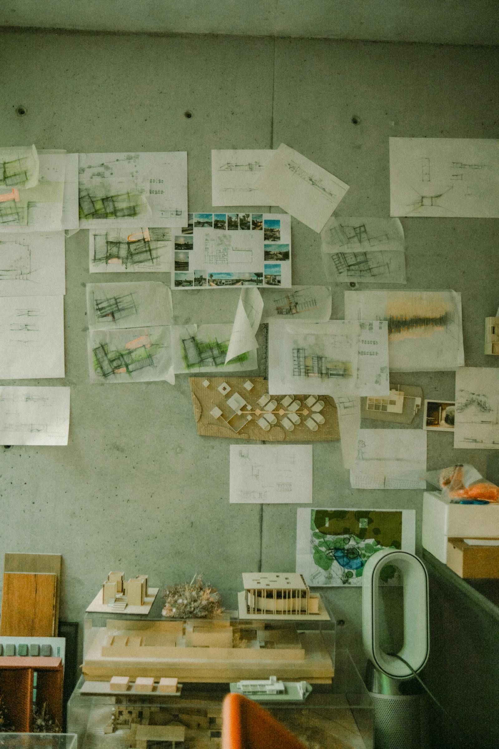 A creative architectural workspace showing blueprints and design models