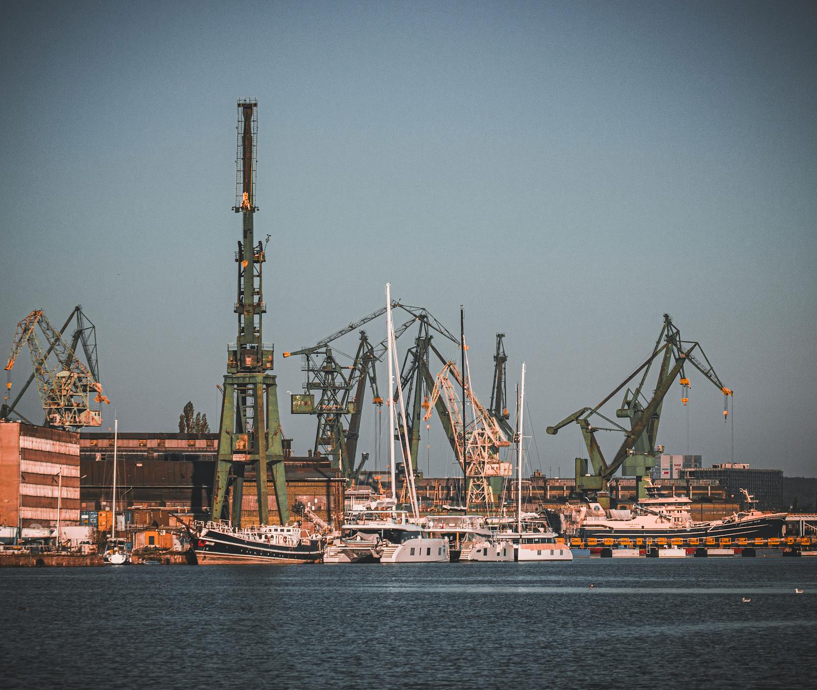 A working industrial port with shipyard cranes and dock facilities
